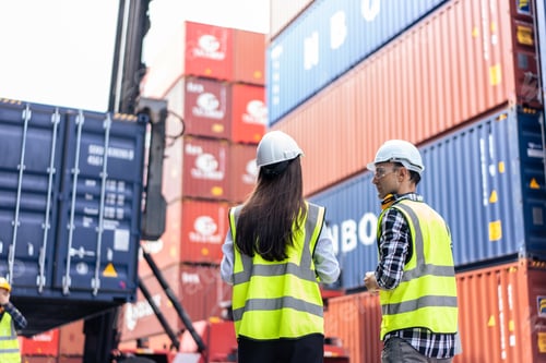 Preview: Caucasian business man and woman worker working in container terminal.