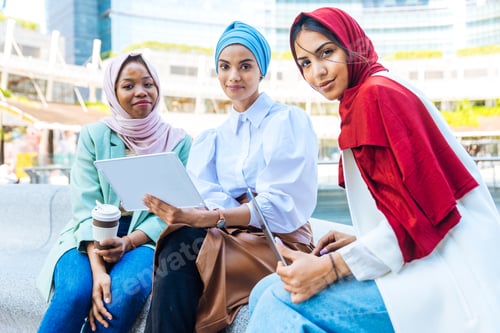 Preview: Beautiful muslim girl wearing hijab bonding outdoors