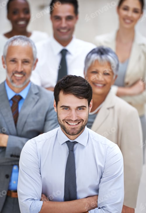 Preview: Portrait of a smiling businessman surrounded by a group of his colleagues