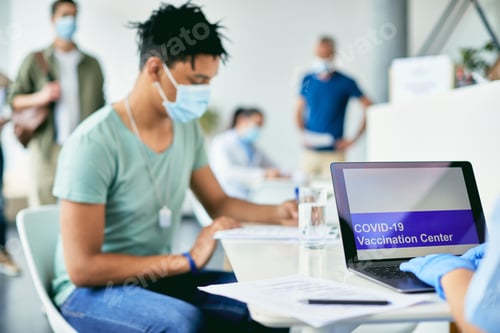 Preview: Close-up of nurse working on a computer at coronavirus vaccination center.
