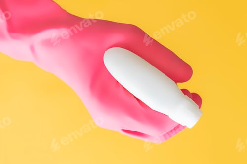 Preview: female hand in pink gloves cleaning concept on solid color background, housewokr concept f