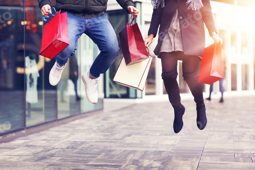 Preview: Legs of couple with shopping bags after shopping in city
