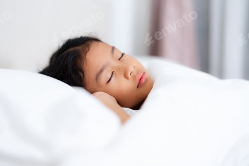 Preview: Little girl sleeping peacefully in white bedding