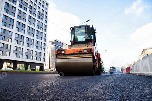Preview: Daytime Urban Street Paving as a Large Roller Compacts New Asphalt Concrete