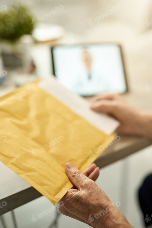 Preview: Fragment photo of elderly man unpacking postal parcel