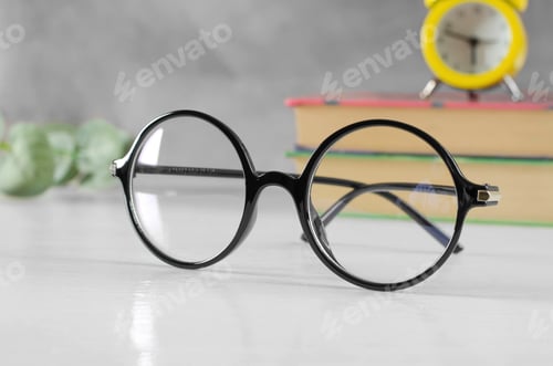 Preview: Stylish glasses for vision in a black round frame on the table