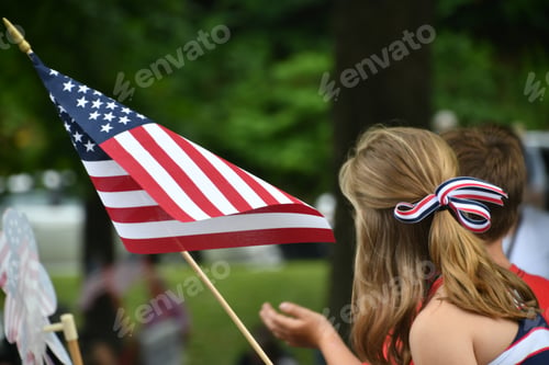 Preview: Watching the Independence Day Parade on the 4th of July while waving an American flag.
