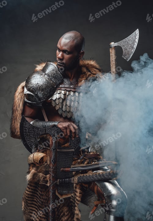 Preview: Tribal authentic soldier with axes in foggy background looks away
