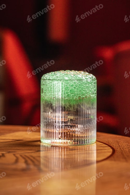 Refreshing Green Cocktail with Bubbles on Wooden Table