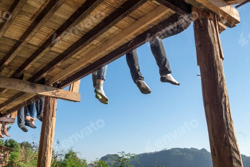 Preview: Tourists sitting legs hanging on terrace