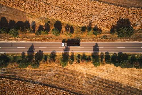 Preview: Top view aerial photo of truck on the road through plain landscape countryside