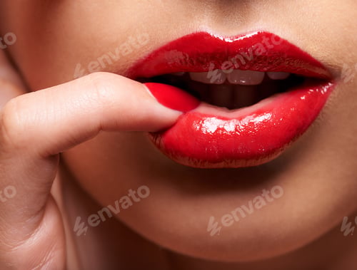 Preview: Desire comes in red. Cropped shot of a woman pressing her finger against her lip.