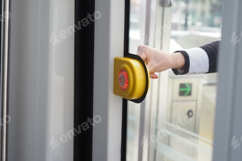 Preview: finger presses button to open doors in subway car.