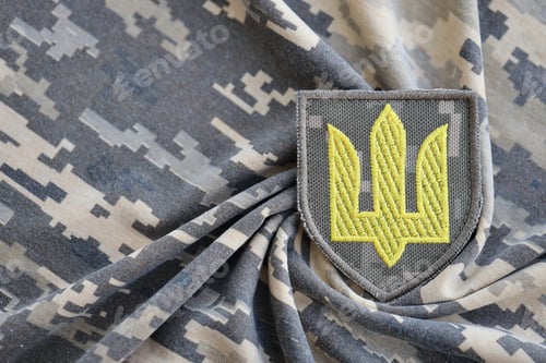 Preview: Symbol of Ukrainian army on the camouflage uniform of a Ukrainian soldier