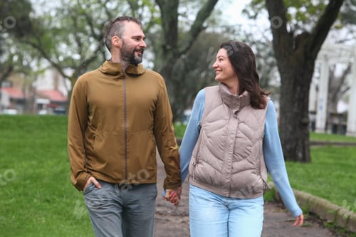 Preview: Mid Adult Couple Walking in the Park on a Cloudy Autumn or Spring Day