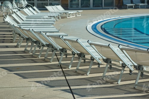 Preview: Outdoor swimming pool with chairs in hotel resort