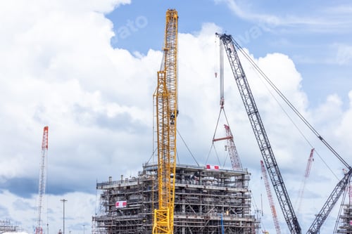Preview: Construction site with construction crawler cranes and multi storey unfinished buildings