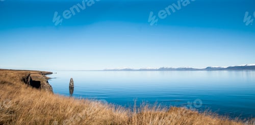 Preview: Icelandic landscapes full of green grass, sea and blue sky.