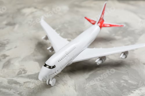 Preview: Toy airplane on grey background, closeup. Travel concept