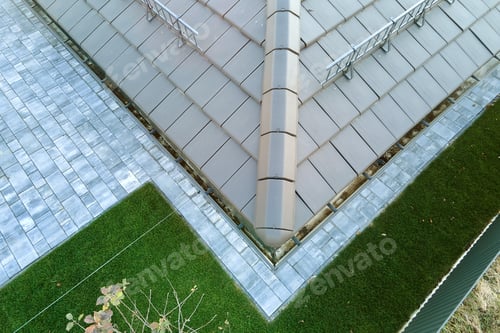 Preview: Closeup of house roof top covered with ceramic shingles. Tiled covering of building