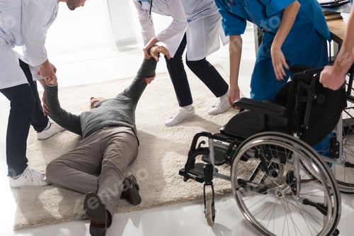 Preview: cropped image of doctors helping unconscious man in a hospital