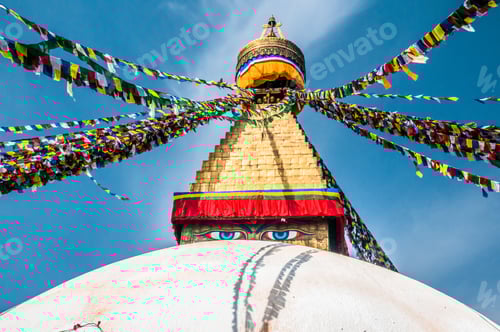 Preview: Monumental Architecture with Colorful Prayer Flags Under Blue Sky