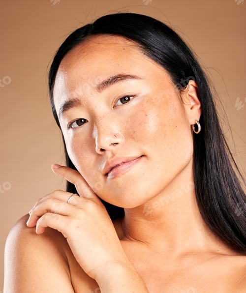 Preview: Asian woman, face and portrait smile for skincare, cosmetics or beauty against brown studio backgro