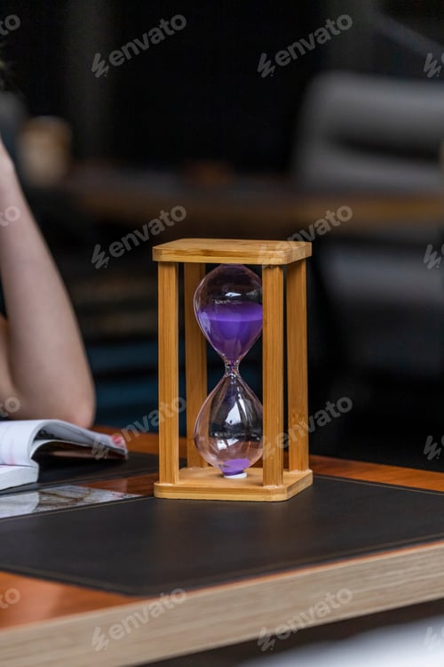 Preview: Photo of wooden hourglass on table