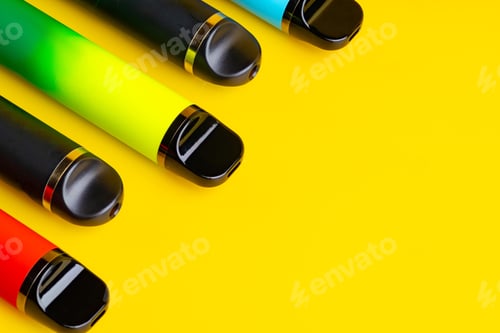 Preview: Colorful disposable electronic cigarettes on yellow background