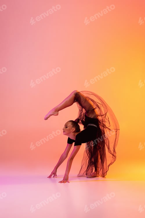 Preview: Portrait of little girl, rhythmic gymnastics artist isolated on pink yellow studio background in