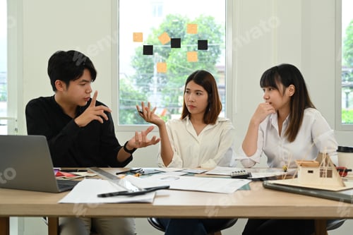 Preview: Group of creative people working together of architectural project, collaborating with team leader.