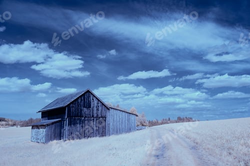 Preview: Scenic infrared landscape of a rustic wooden building in the field with lush green grass