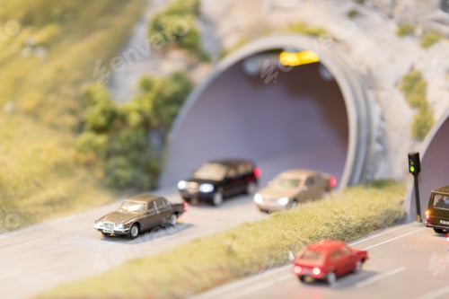 Preview: September 04, 2019: cars, with lights on, entering and leaving a tunnel