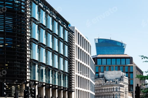Preview: Cityscape of London with modern office buildings against blue sky