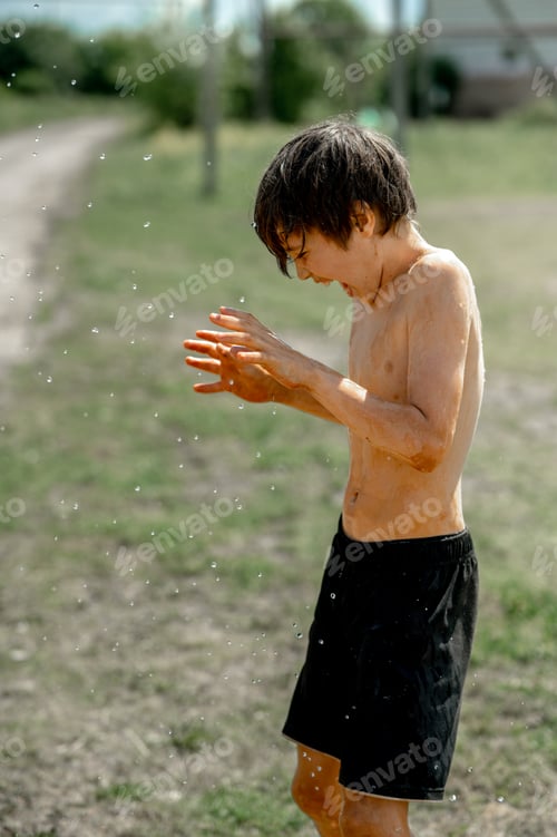 Preview: boys are doused with cold water from a hose.