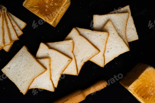 Preview: Top view of white bread slices on a black background