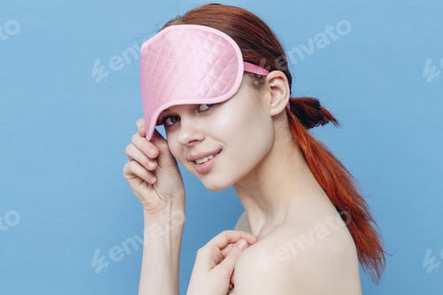Preview: happy woman with sleep mask on her head blue background Copy Space