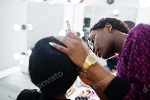 Preview: African American woman applying make-up