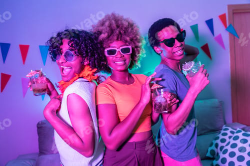 Preview: Three happy multi-ethnic friends partying at home
