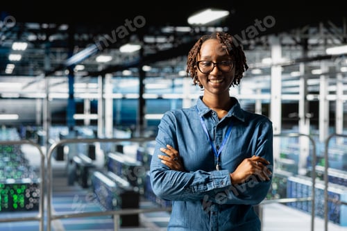 Preview: Portrait of smiling black expert works on data center industrial platform