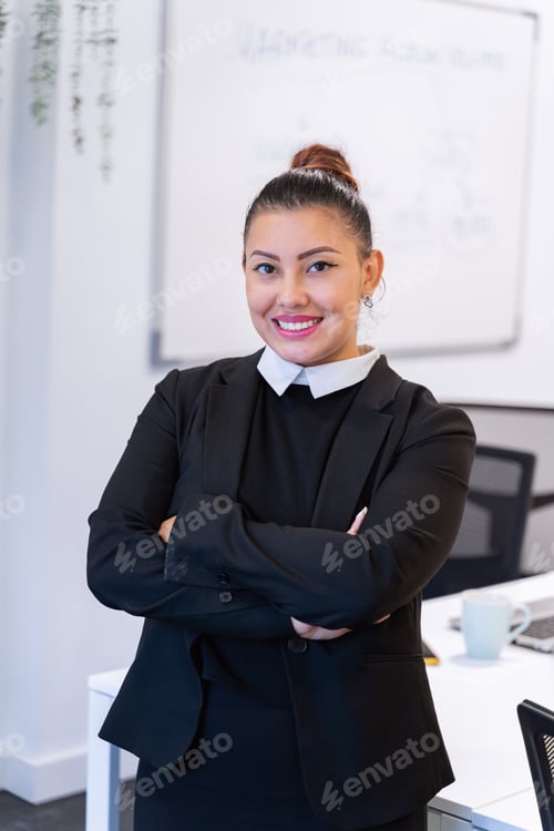 Preview: Portrait of a professional businesswoman smiling while posing standing in the office.