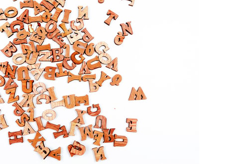 Preview: Jumbled letters made of wood close up