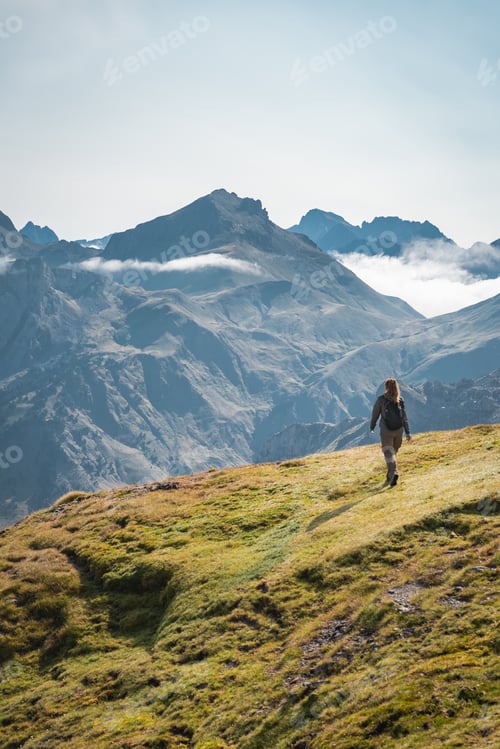 Preview: Young Woman With A Backpack on The Top Of a Beautiful wild Landscape.