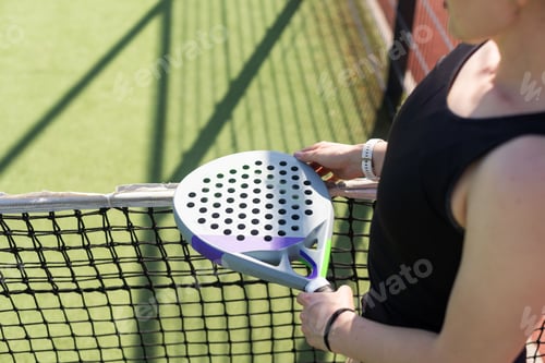 Preview: Woman padel tennis player training on court. Woman using racket to hit ball.
