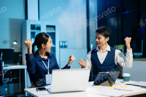 Preview: Asian business team celebrating success with high five, showing teamwork