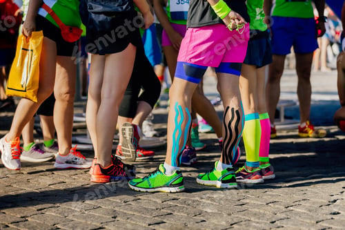 Preview: legs female runners with kinesio tape and compression socks