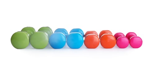 Preview: Many colorful dumbbells on white background. Fitness equipment