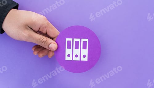 Preview: Male hand holding folder shape symbol on violet background
