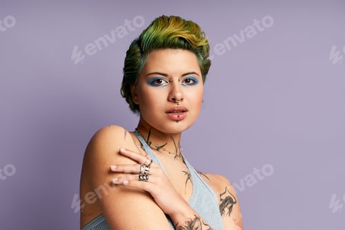 Preview: Young woman with vibrant style and striking makeup expresses confidence in trendy fashion