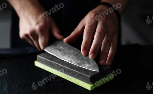 Preview: Man Polishes Kitchen Knife On Whetstone
